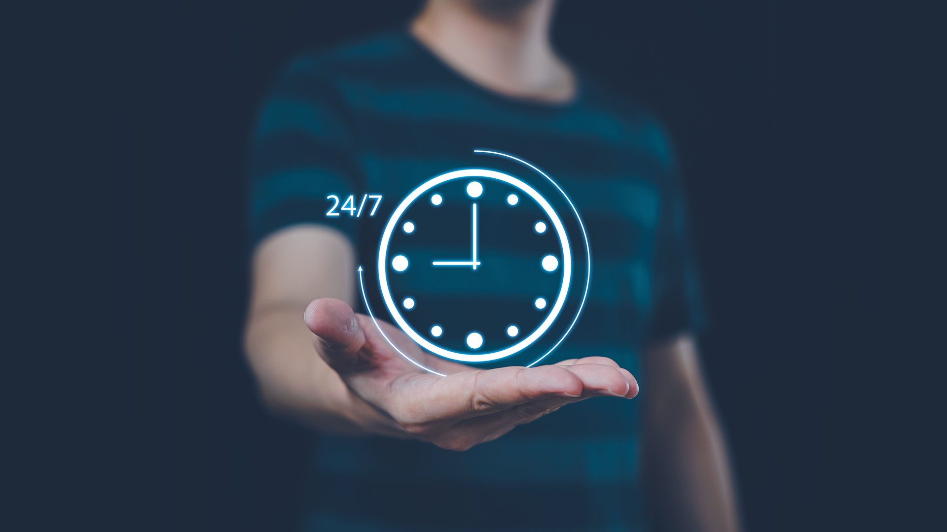 Nonstop service 24 hr concept. Man hand holding virtual 24-7 with clock on hand for worldwide nonstop and full-time available contact of service concept.